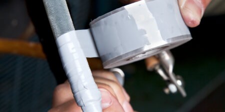 Worker wrapping cable in 3M Self-Fusing Silicone Rubber Electrical tape
