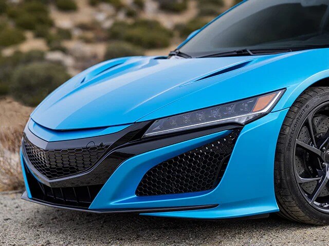 Close up of sports car front hood area with ocean shimmer blue color car wrap film
